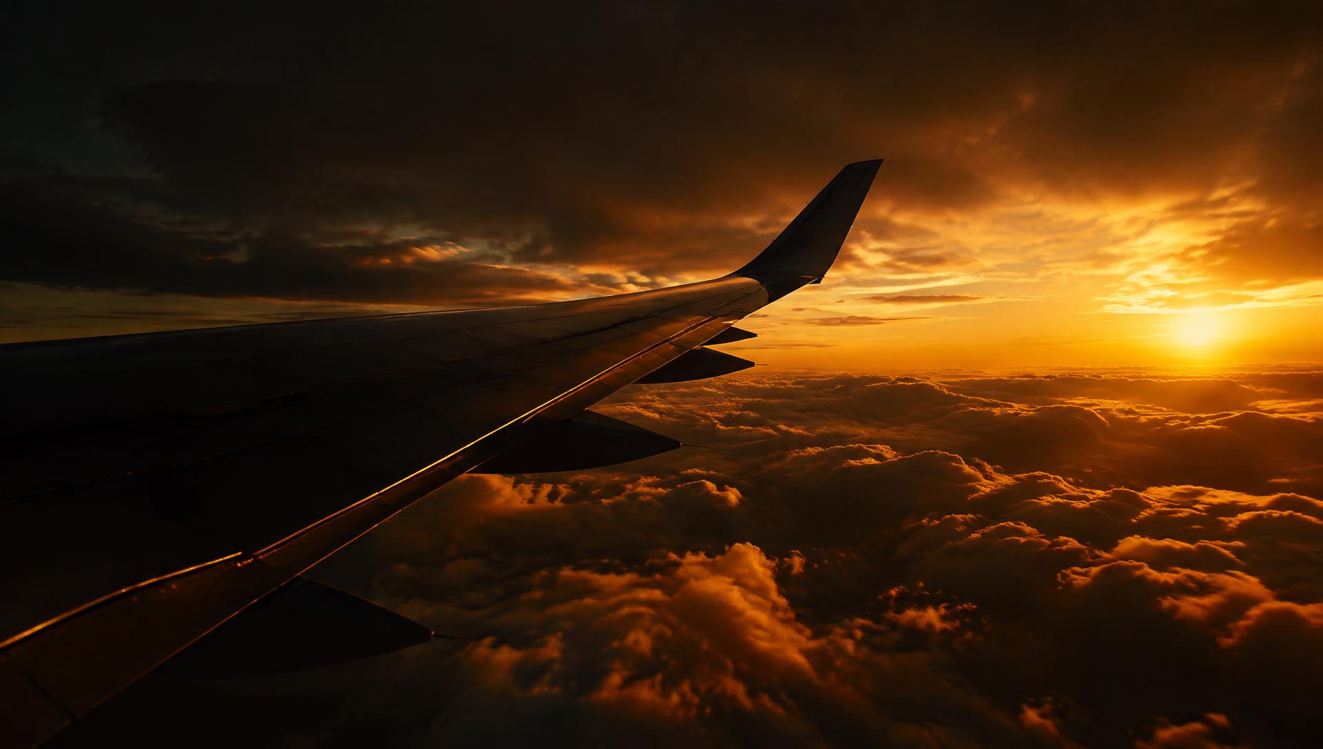 Aircraft above the clouds at sunset